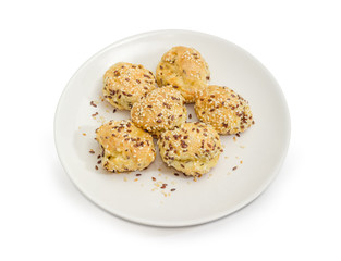 Savory profiterole sprinkled with flax and sesame seeds on dish