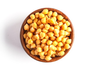 Wooden bowl of preserved (boiled) chickpeas isolated on white background, top view