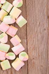 Marshmallows on wooden table. 