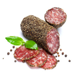 Dried organic salami sausage covered with pepper on white background