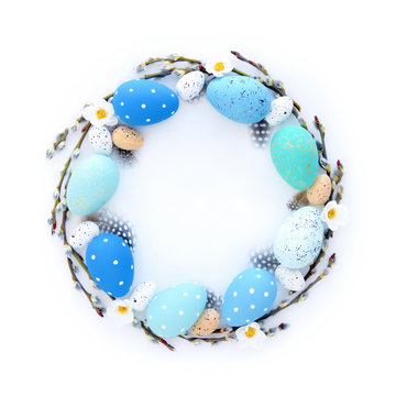 Creative Easter layout made of eggs and willow branches on white background. Circle wreath flat lay concept