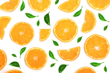 Fototapeta na wymiar Slices of orange or tangerine decorated with green leaves isolated on white background, top view. Fruit composition