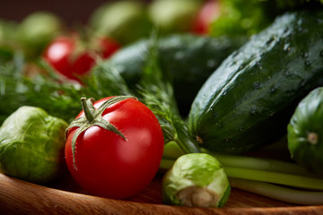 Fresh vegetables composition over wooden background, close-up, flat lay, shallow depth of field