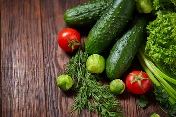 Fresh vegetables composition over wooden background, close-up, flat lay.
