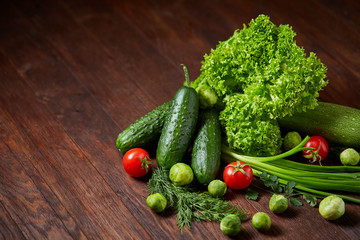 Fresh vegetables composition over wooden background, close-up, flat lay.