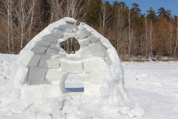 Igloo unfinished on a snow glade in the winter