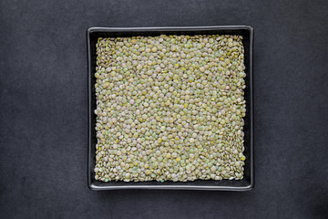 Green Lentil Grains in Black Plate on Black Background Surface