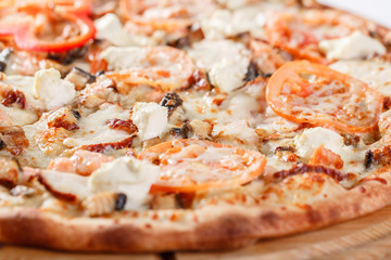 Italian kitchen and cooking concept. Hot tasty sliced with salmon, eel, seafood, tomato. Eat delivery concept.