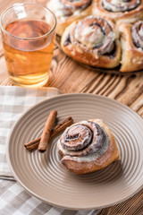 Bun roll with tea on a wooden table