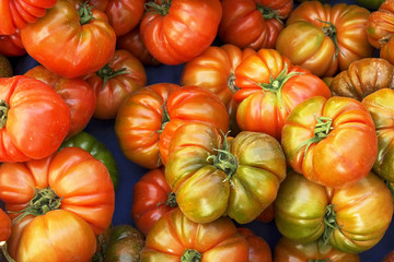 Clean eating concept. Bunch of ripe juicy fresh organic yellow green cherry mixed tomatoes pile at local produce farmers market. Healthy diet, spring summer detox. Vegan raw food. Close up, background