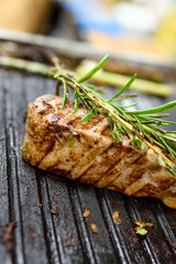 grilled tuna steaks on grill with rosemary