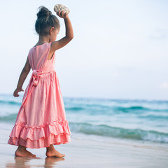 girl throws a stone at sea.