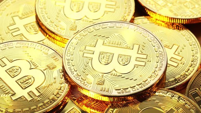 Gold coin bitcoin slowly scroll clockwise. Macro shot. 4K video.