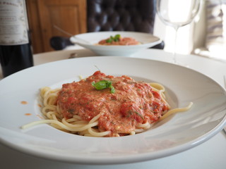 two plates of Spaghetti on a white plate close up