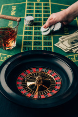 Woman placing a bet on table with roulette