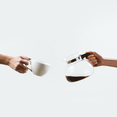 cropped view of hands with coffee cup and glass pot, isolated on white