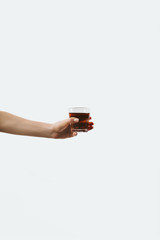 cropped view of hand holding glass with morning coffee, isolated on white