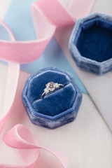 White golden wedding ring with diamonds in blue vintage velvet box