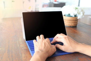 Hand of man is placed on a computer laptop and have empty black screen.