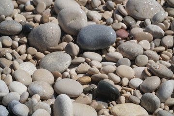 Fototapeta na wymiar sea stones,stones on the beach,.vacation at sea, seashore in Albir, a Spanish beach