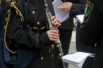 Fototapeta na wymiar Horizontal View of Close Up of Musician Playing Clarinet in Black Uniform. Taranto, South of Italy