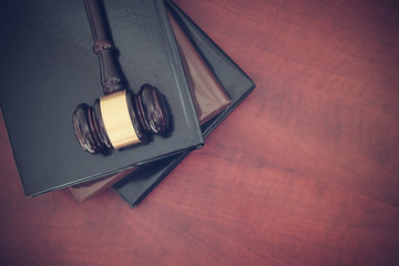 Judge gavel and legal books on wooden table with room for text