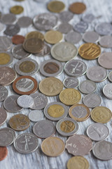 Different collector coins and piggy bank on the wooden background