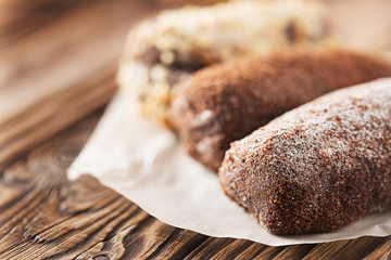 Chocolate cake on a wooden background. Three kinds of cakes.