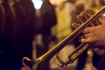 Fototapeta na wymiar Horizontal View of Close Up of Musician Playing Trumpet at night. Taranto, South of Italy