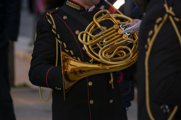 Horizontal View of Close Up of Musician Playing Horn in Black Uniform. Taranto, South of Italy