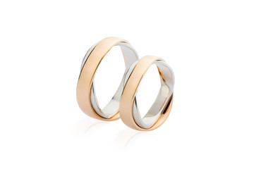 Two white and rose gold wedding rings isolated on white background