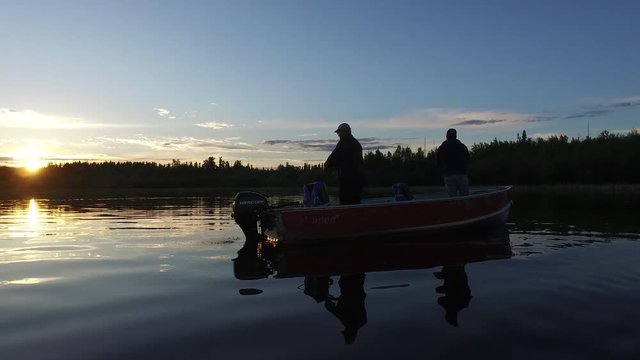 Men fishing at sunset