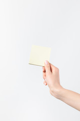 cropped shot of woman holding blank sticky note in hand isolated n white