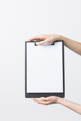 partial view of woman holding blank clipboard in hands isolated on white