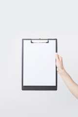 partial view of woman holding blank clipboard in hand isolated on white