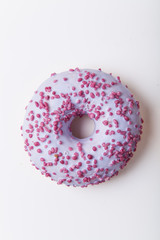 Glazed donut with sweet sprinkles on white background