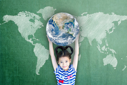 Happy Asian girl child student raising globe on school chalkboard for world literacy and gender equality concept. Elements of this image furnished by NASA