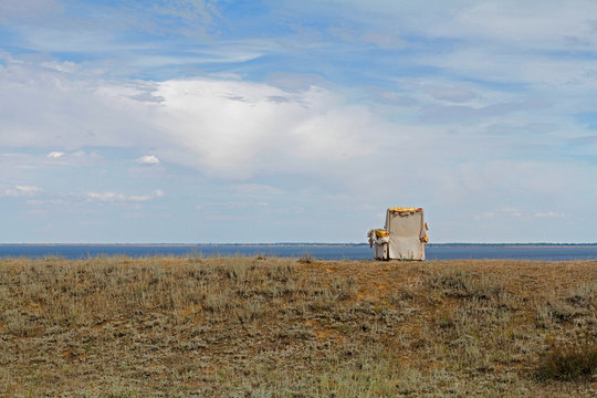 Old abandoned armchair on the bank of the river