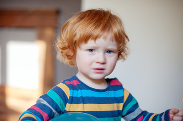 Funny dissatisfied redhead boy closeup
