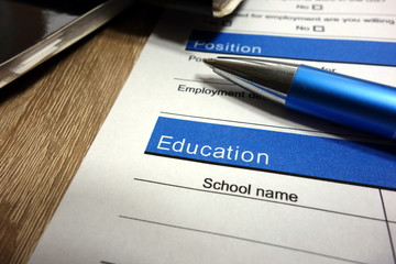 CV (curriculum vitae) for filling, pen and documents on wooden table