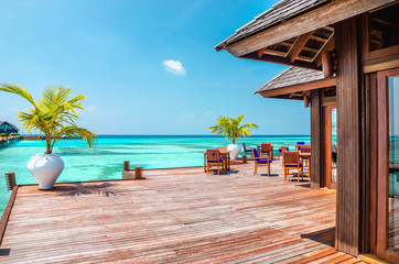 A wooden restaurant on the water against the backdrop of the azure waters, Indian Ocean, Maldives