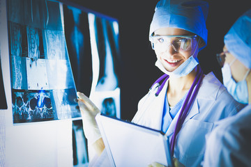 Two female women medical doctors looking at x-rays in a hospital.