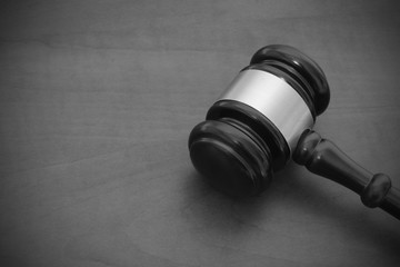 Judge gavel on brown wooden table with copyspace, legal concept