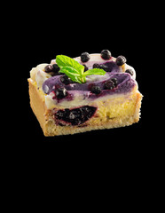 piece home made dessert with vanilla cream decorated with blueberries and mint