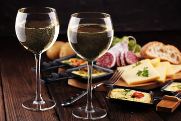 Delicious traditional Swiss melted raclette cheese on diced boiled or baked potato.