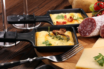 Delicious traditional Swiss melted raclette cheese on diced boiled or baked potato.