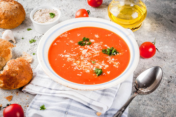 Tomato soup, Gazpacho in white bowl on grey stone background, with ingredients  Copy space
