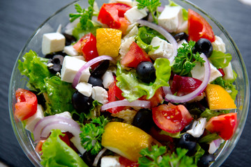 Fresh vegetable salad with feta cheese, fresh lettuce, cherry tomatoes, red onion and pepper