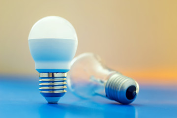 Led light bulb lay next to incandescent bulb
