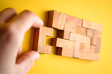 woman hand put wooden blocks for finishing task